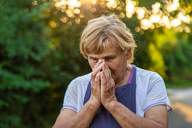 istock An elderly woman prays in the garden. selective focus. 2207819210