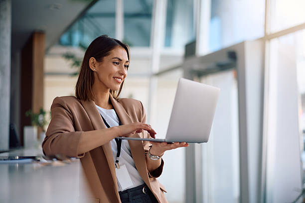 istock Happy female manager working on laptop in the office. 2207820715