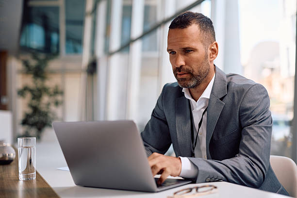 istock Mid adult businessman working on a computer in the office. 2207820982