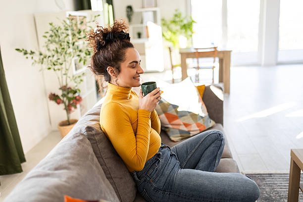 istock Young woman enjoying fresh coffee at home 2207821452