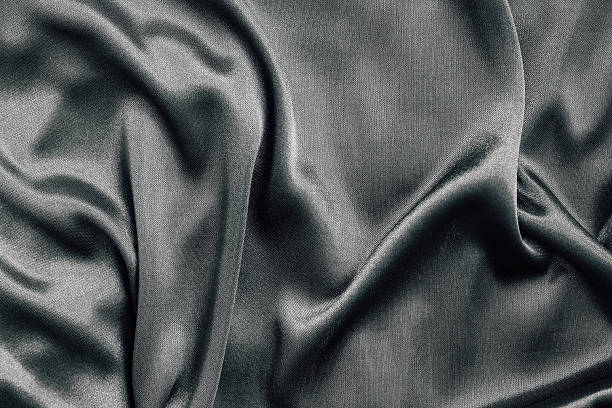 Soft, lustrous fabric draping elegantly in natural light creates a calming ambiance