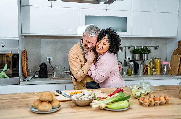 istock Mature couple dancing together while preparing a meal 2207823096