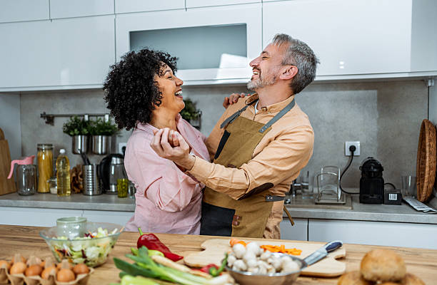 istock Mature couple dancing together while preparing a meal 2207823118