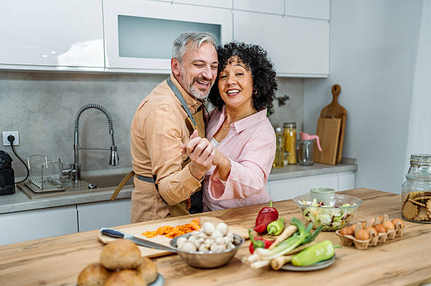 istock Smiling mature couple dancing together in their kitchen 2207823164