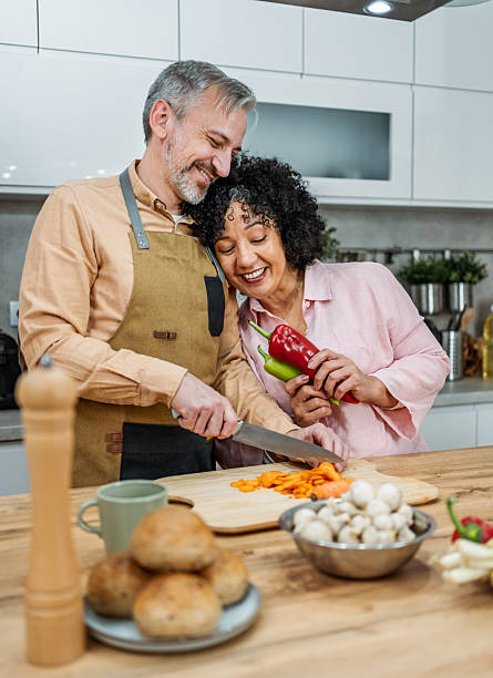 istock Mature couple preparing food in the kitchen 2207823202