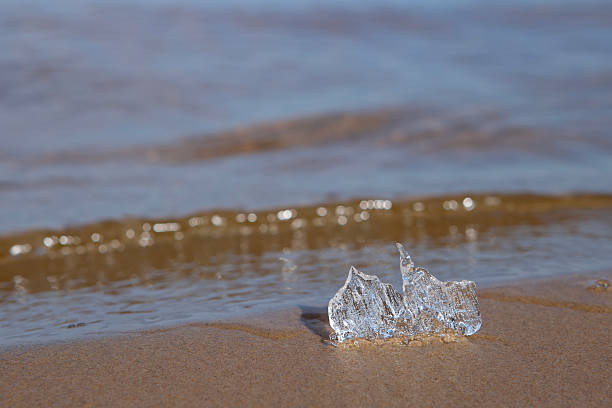 A small piece of ice on a sandy beach, the melting ice floe