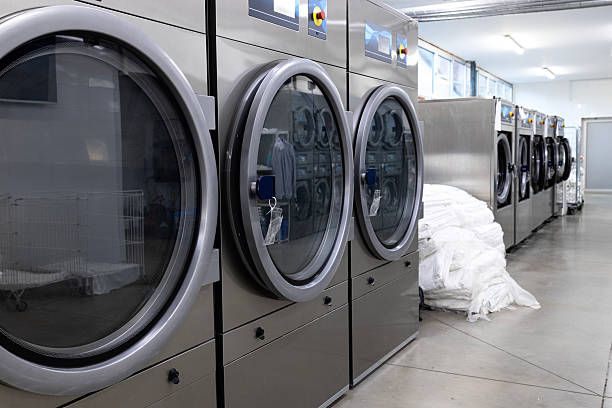 istock Laundromat laundry service. Washing and drying machine in a row. 2207823870