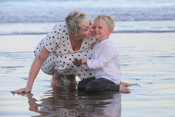 istock cheerful mother with her little boy by the ocean 2207824747