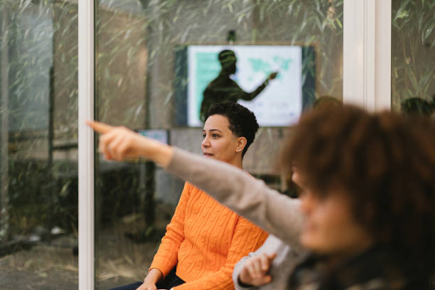 istock Businesswomen pointing at something during a working meeting 2207825550