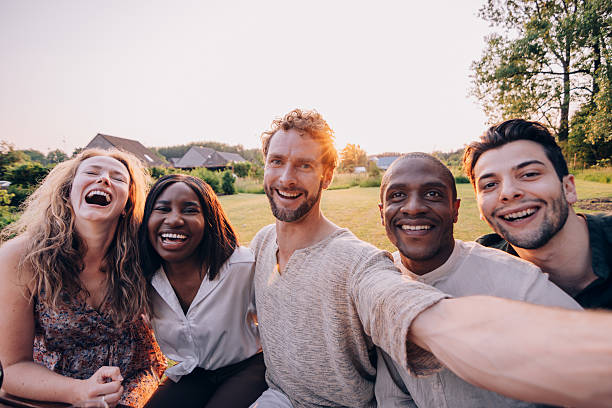 istock Five happy friends taking a selfie in a backyard during sunset 2207825838