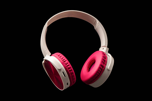 istock Pink and white headphones isolated on a black background. 2207826407