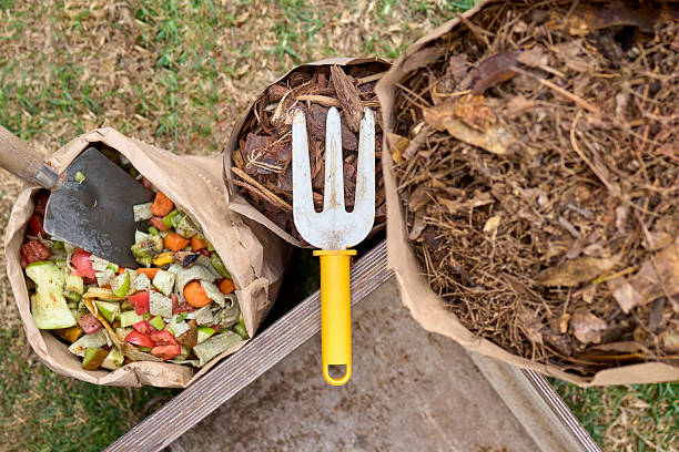 istock Compost materials in paper bags with gardening tools 2207828037