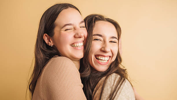 istock Two women embracing with joyful smiles 2207830202