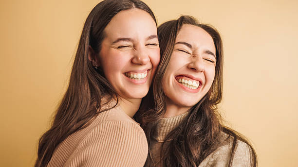 istock Two friends sharing a joyful moment together 2207830747