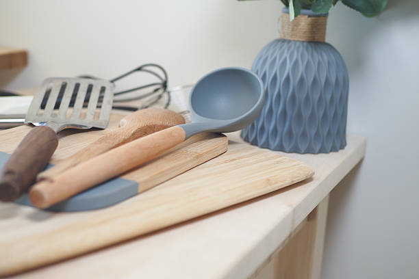 istock Stylish kitchen utensils and a vase are displayed on the countertop 2207831352