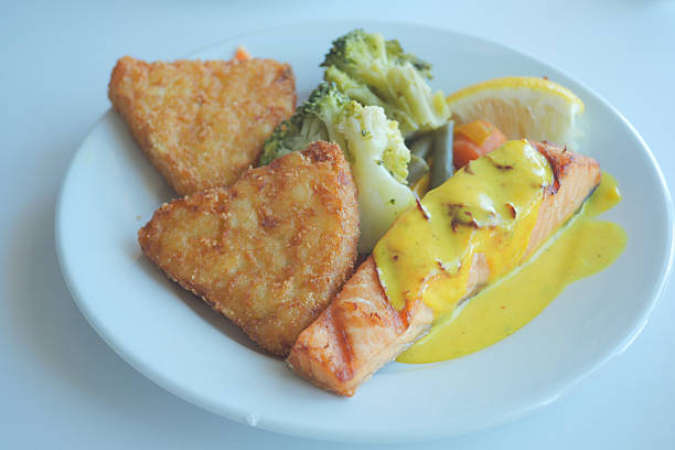 grill salmon served with fresh vegetables on a plate .