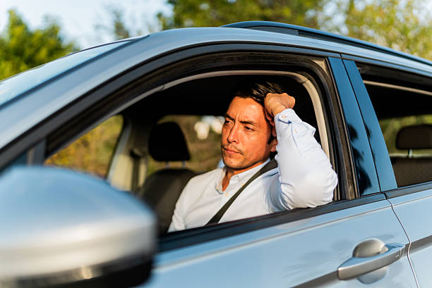 istock Mid adult man driving car 2207832688