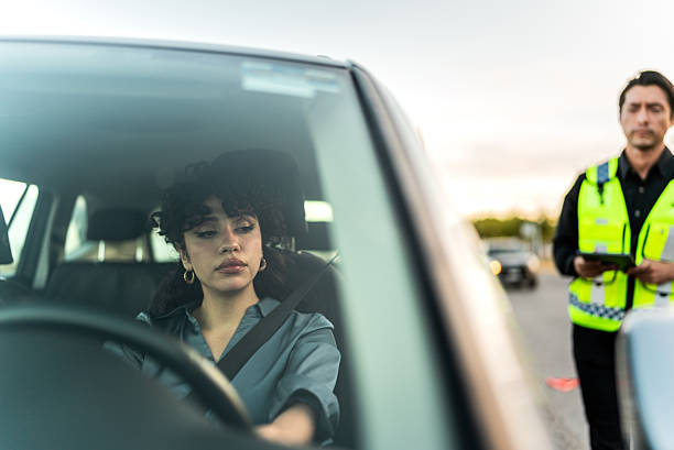 istock Young woman leaving after being ticketed by traffic cop 2207832727