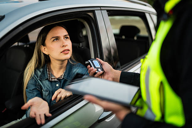 Young woman doing driver alcohol test on street
