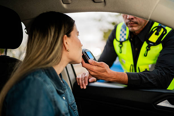 istock Young woman doing driver alcohol test on street 2207832797