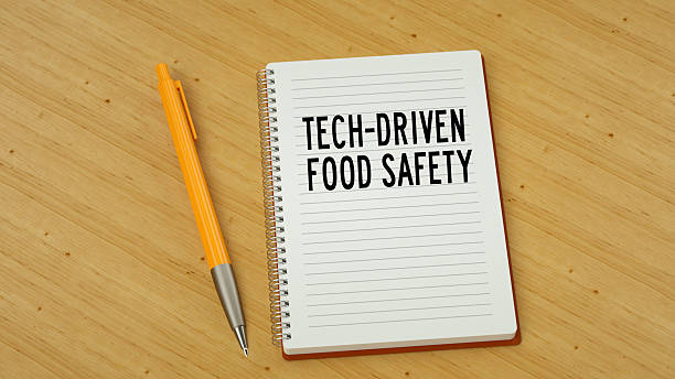 istock Tech-driven food safety text message on note pad. Wooden background and pen 3d render 2207833736