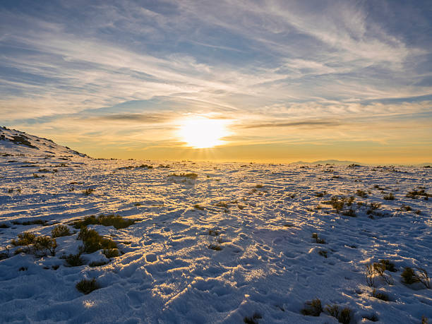 Sunset horizon in the mountains on snowy terrain