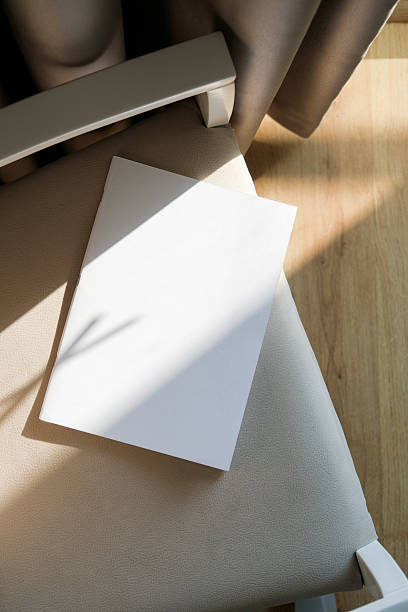 istock blank magazine mockup on soft armchair , shadow overlay 2207836615