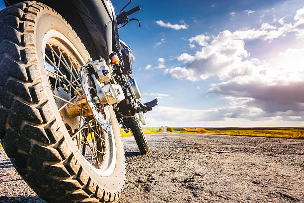 istock Studded cross motorcycle wheel on the ground level. 2207838248