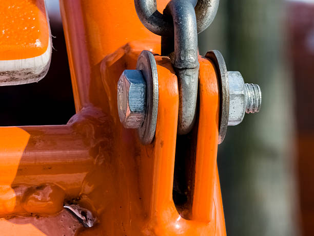 istock Close up of bolt fastener with washers and nuts with chain. View from an angle. 2207838418