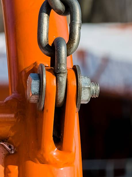 istock Close up of bolt fastener with washers and nuts with chain. Vertical. 2207838439