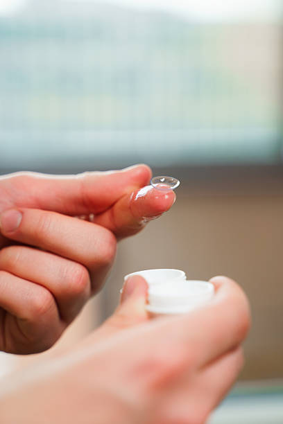 istock Eyesight correction with optical lens. Closeup contact lens for vision correction in hands. 2207840072