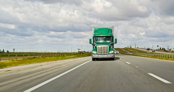 istock A Green Truck Driving on Interstate 5 on an Overcast Day 2207842821
