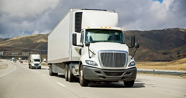 istock White Cargo Trucks on Interstate 5 in California 2207842852