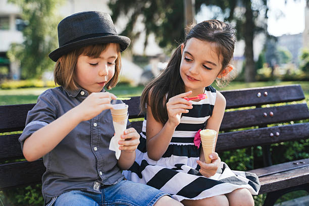 istock Cheerful Kids Enjoying Ice Cream in Summer Park 2207843847