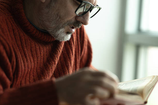 istock Elderly man reading a book, enjoying his retirement time 2207844451