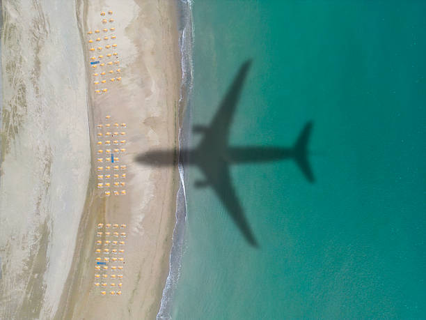 istock Aerial view airplane shadow and beach 2207844776