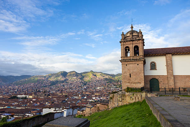 Peru, Lima Barranco, beautiful Yellow church with Palm trees and flowers on sunny morning.
