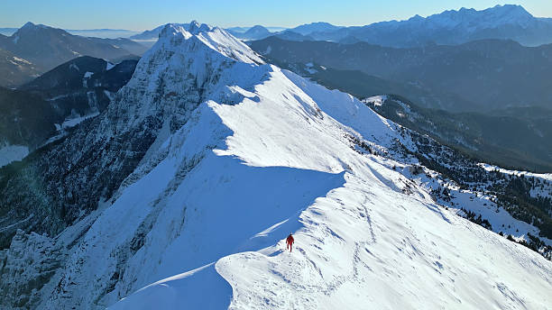 istock Snowy mountain peak with a lone climber, inspiring adventure and tranquility. 2207847582