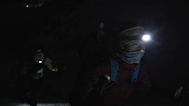 istock Headlamp illuminates night hike, teamwork, and adventure. 2207847606
