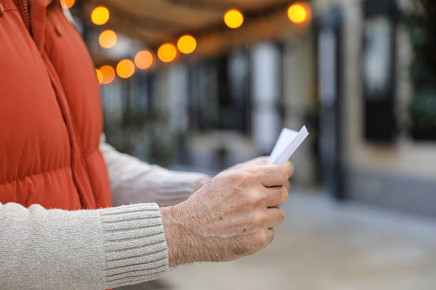 istock Senior tourist enjoying a letter during city stroll 2207848792