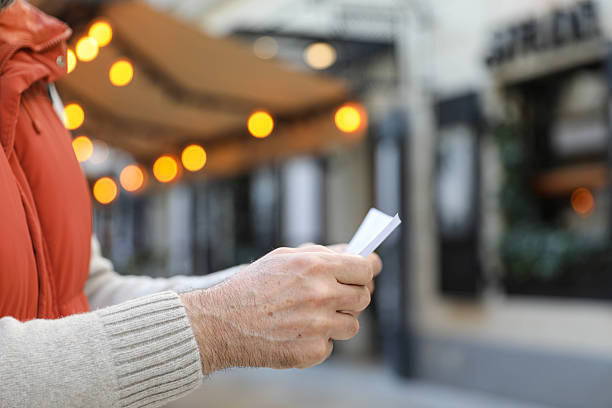 Man in his 50s looking at a bill. Close-up.