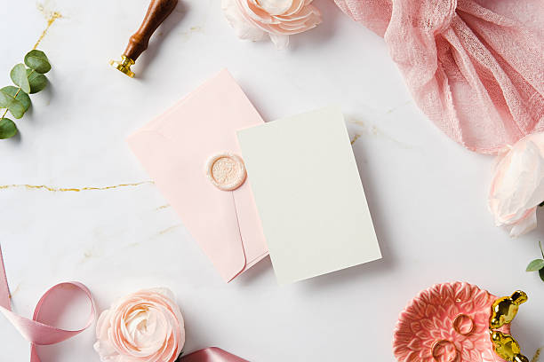 istock Stylish wedding invitation flat lay featuring pink envelope, wax seal, blank card, and elegant marble accents. Wedding stationery top view. 2207849155