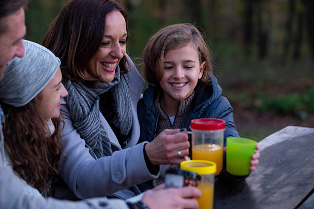 istock family sitting on a bench in the forest 2207849281