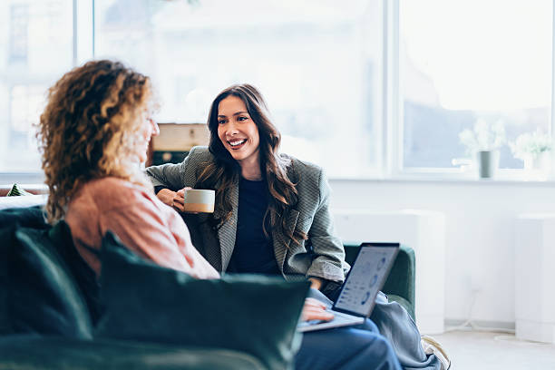 istock Two Women Having a Friendly Conversation in a Relaxed Living Room Setting 2207850477