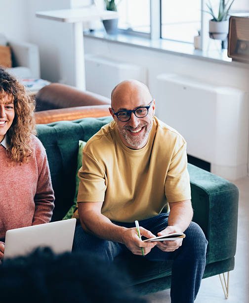 istock Smiling Colleagues Collaborating in a Modern Office Space with Natural Light 2207850517
