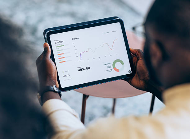 istock Business Person Analyzing Financial Charts and Reports on a Digital Tablet 2207850536