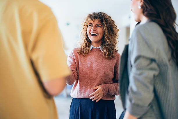 Group of People Sharing a Laugh in a Professional Setting