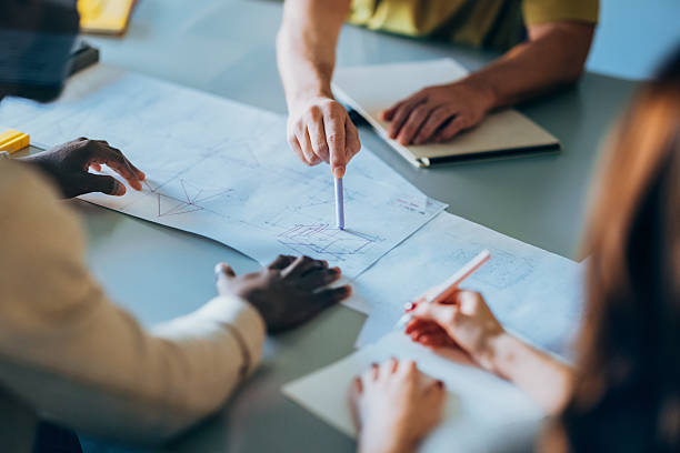 istock Collaborative Team Reviewing Blueprints During a Planning and Design Meeting 2207850554