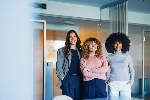 istock Three Confident Women Smiling in a Modern Office Environment 2207850565