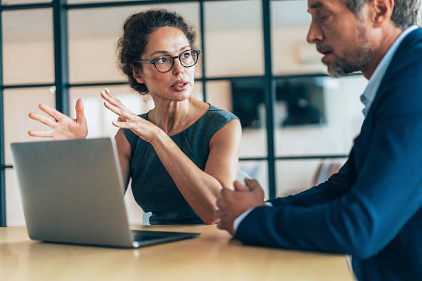 istock Two business coworkers talking 2207851984